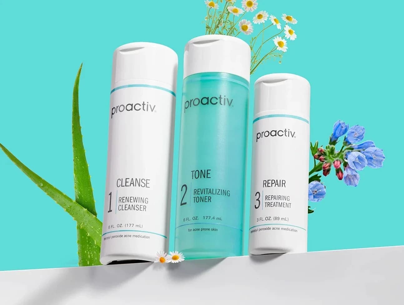 Proactiv skincare products arranged with flowers on a turquoise background.